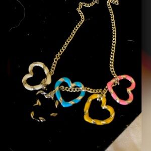 Melania Clara Necklace with 5 different colored silver hearts.